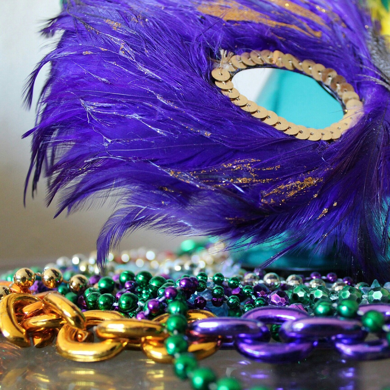 Purple Mardi Gras mask with strings of beads