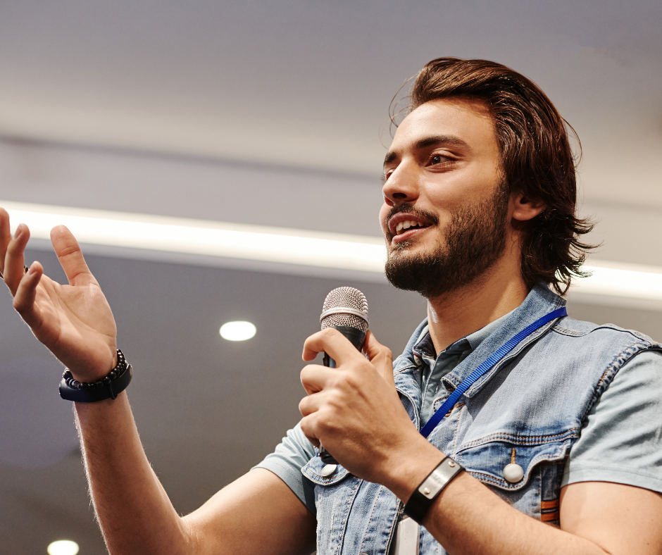 A man speaking with a microphone in his hand